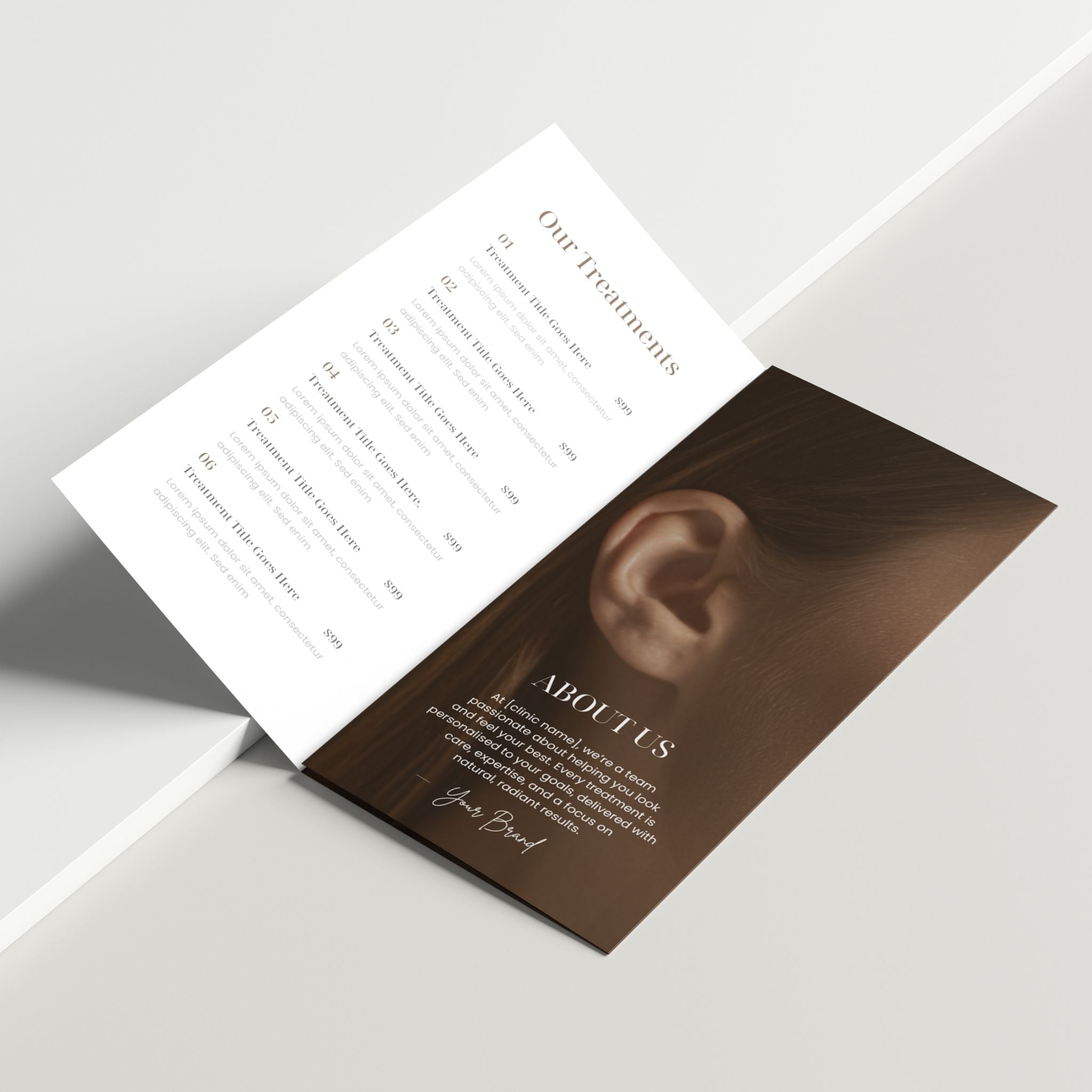Open brochure with an ear on one page and text on the other, on a light grey background.
